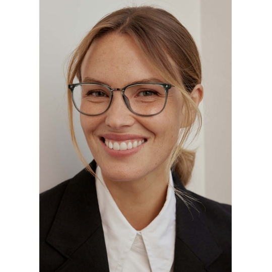 Woman wearing CHARMANT Japanese Made eyeglasses in blue