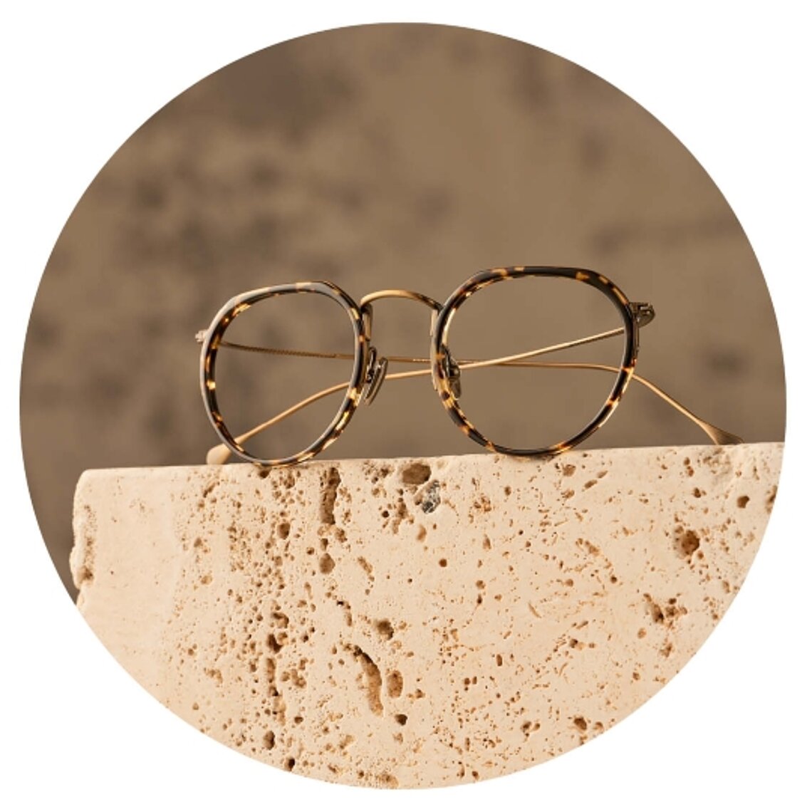 Minamoto eyeglasses displayed on stone surface in minimalist setting